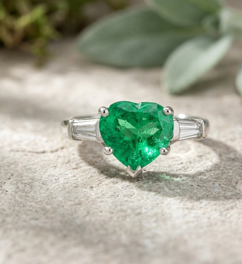 Columbian Emerald and Diamond Three-Stone Ring featuring Heart Shape Center and Tapered Baguette Accents