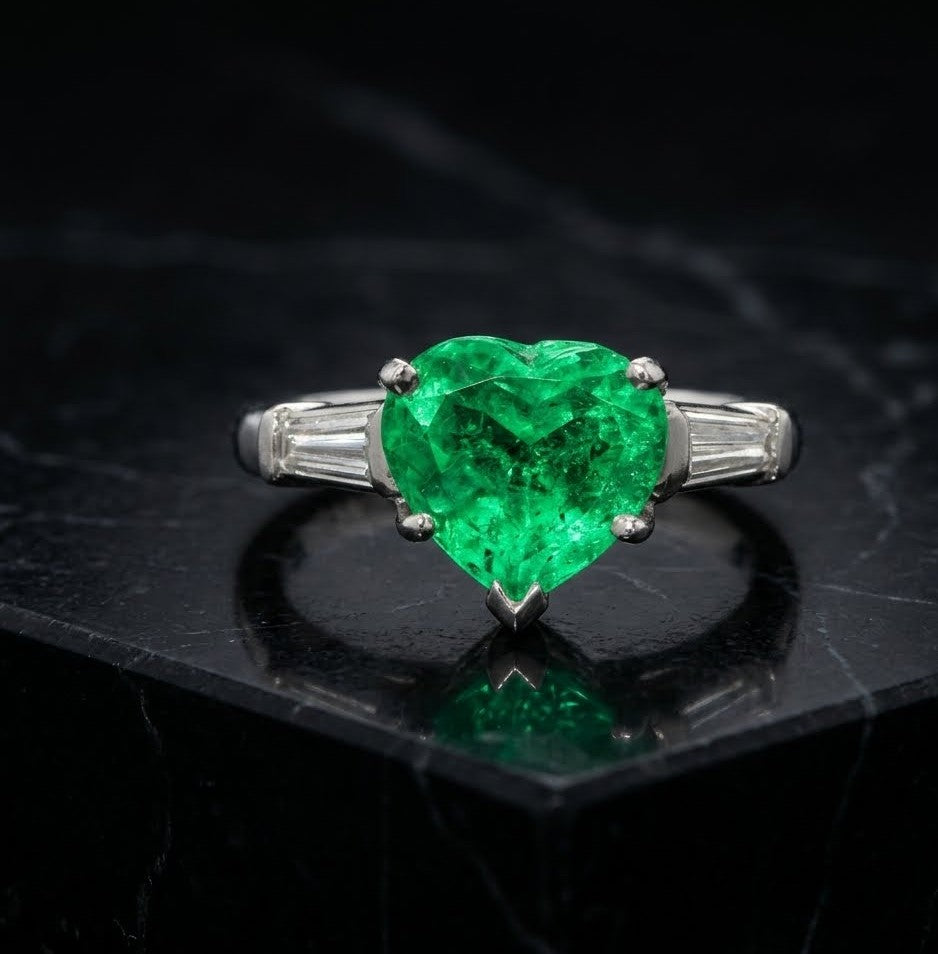 Columbian Emerald and Diamond Three-Stone Ring featuring Heart Shape Center and Tapered Baguette Accents