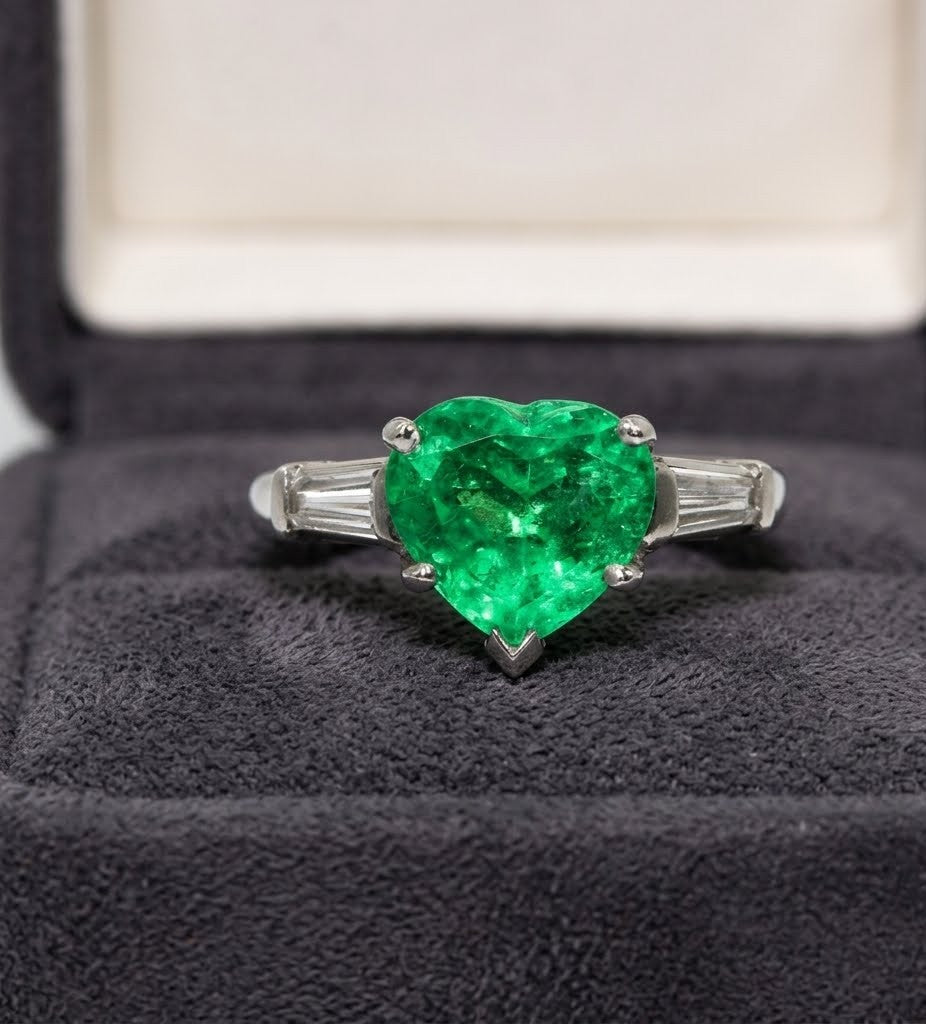 Columbian Emerald and Diamond Three-Stone Ring featuring Heart Shape Center and Tapered Baguette Accents